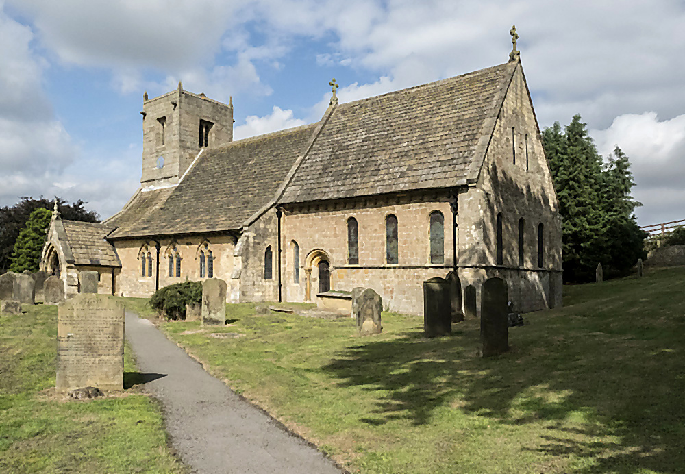 St Oswald's viewed from the churchyard, the path leading toward the porch
