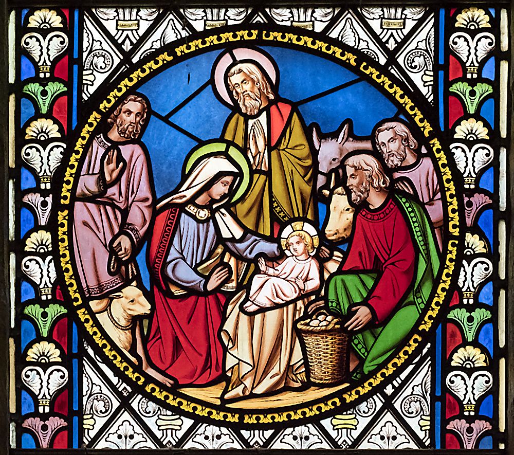 A roundel of Victorian stained glass at St Oswald's, depicting a Nativity scene framed by colourful Gothic foliage