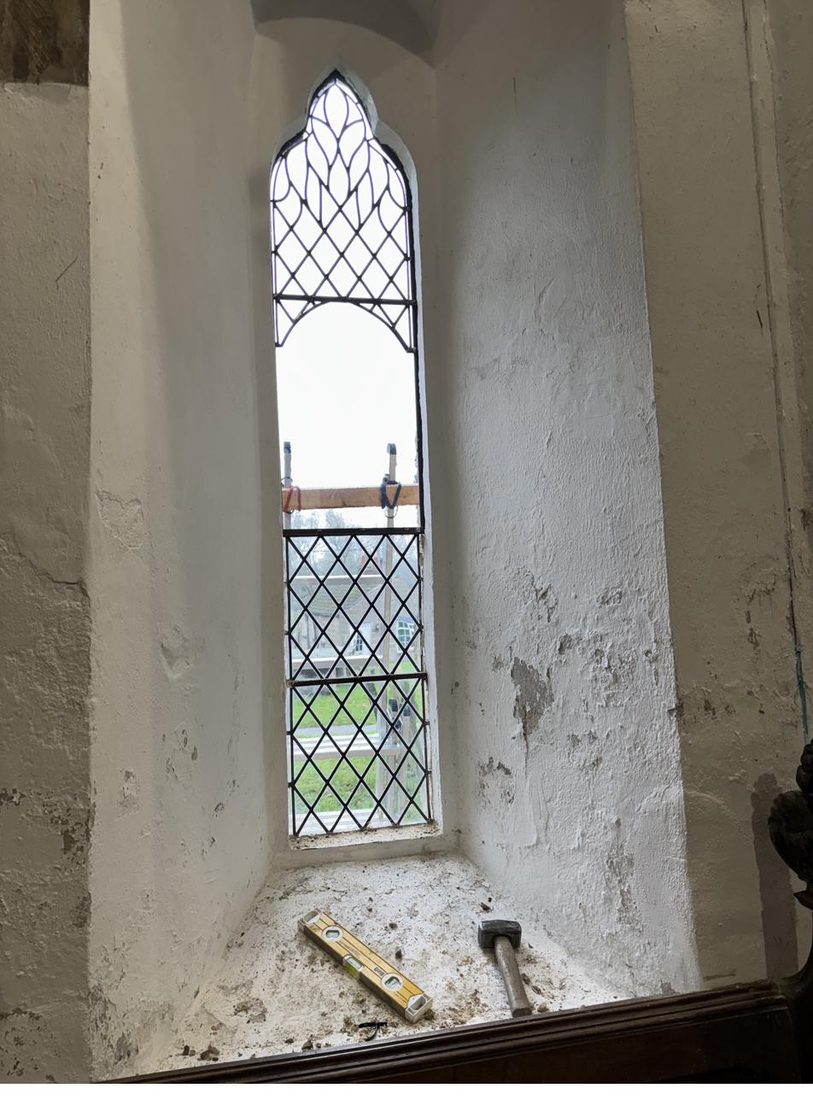 The lancet window at St Oswald's fitted with its new clear protective glazing, before the medieval panel was reinstated inside